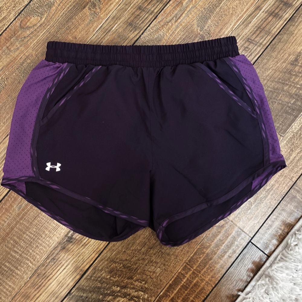 Dark purple under armor running shorts.